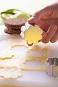 Cutting out flowers from cheese slices