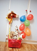 Toy box with plush toys and blown up balloons