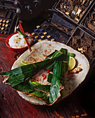 Monkfish in coconut milk on a banana leaf