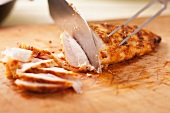 Cutting grilled chicken breast into thin strips