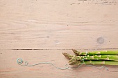 Green asparagus on wooden background