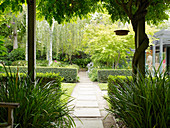 View of landscaped garden and flagstone path from terrace