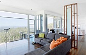 Corner sofa in open-plan interior with panoramic view of landscape
