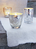 White cloth and silver tealight holders on step