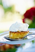 A slice of vanilla flan with cream