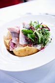 Soused herring with a baked potato and salad
