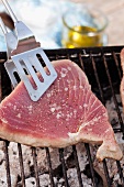 A tuna steak being grilled