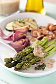 Green asparagus and other vegetables with a walnut dressing