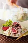 Flash-fried tuna fillets in a sesame crust on a bed of glass noodles