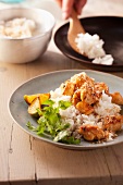 Fried chicken with dessicated coconut on coconut rice