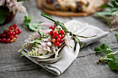 A napkin decorated with astilbe and redcurrants