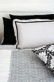 Black and white pillows on bed