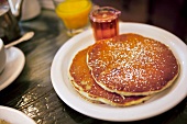 Pancakes, maple syrup and orange juice for breakfast
