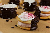 Whoopie pies with chocolate sauce and sugar pearls