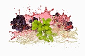 Red and green grapes with wine splash