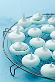 Turquoise meringues on a kitchen rack
