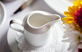 Pitcher of Cream on a Table; Flowers