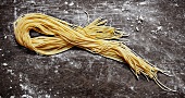 Home-made spaghetti on rustic board