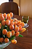 Bouquet of orange tulips on table