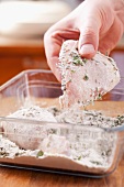 Coat the chicken breast fillet in flour and herbs