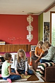 Children playing on rug and sofa in living room