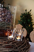 Christmas decor with large fir cone and tea lights