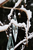 Glass Christmas decorations hanging from twig