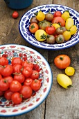 Various tomatoes in ceramic bowls