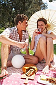 Young couple picnicking in the park
