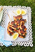 Prawn and chorizo kebabs for a picnic outside on a plate
