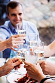 People toasting with glasses of water