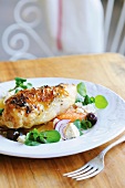 Chicken breast on citrus fruits with watercress, feta & olives