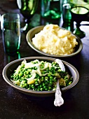 Bowls of green peas and mashed potatoes as side dishes