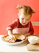 Little girl pinching a nibble of pie