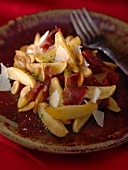 Potato wedges with dry-cured ham and parmesan