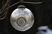 Silver Christmas bauble on branch