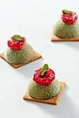 Petit fours with pistachios and raspberry icing