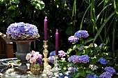 Summery table centre of hydrangeas and candlesticks