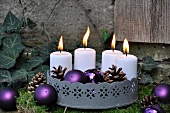 Festive garden decoration: zinc tray with candles on bed of moss