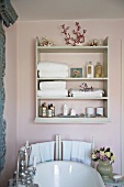 Old fashioned bathroom with a playful 'Shabby Style' with shelves above a bathtub