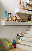 Painted vases on shelves with integrated lights and painted figures on the steps