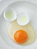 Broken duck egg on a plate (close up)