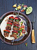 Grilled pork kebabs with zucchini and peppers