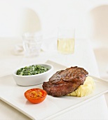 Beef steak with mashed potatoes and spinach