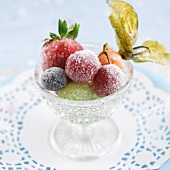 Various sugared fruits in a glass bowl
