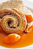 A cinnamon bun with a preserved apricot and parfait brittle