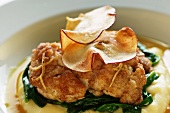 Fried veal sweetbread on apple curry sauce (close-up)