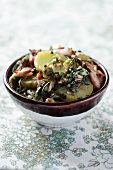 Potato salad with bacon and dandelion