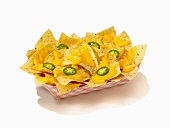 Nachos with Cheese Sauce and Sliced Jalapenos in a Take Out Container