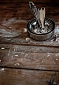 Measuring spoons on a floured wooden surface